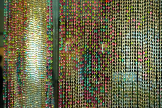Installation view at Microsoft: Spock, Kirk, and McCoy Beaming-In (in-between), installed in front of an 8' x 12' mirror. Each figure constructed from 25,000+ colored faceted beads and silver bicone beads, monofilament, silver painted wooden dowels